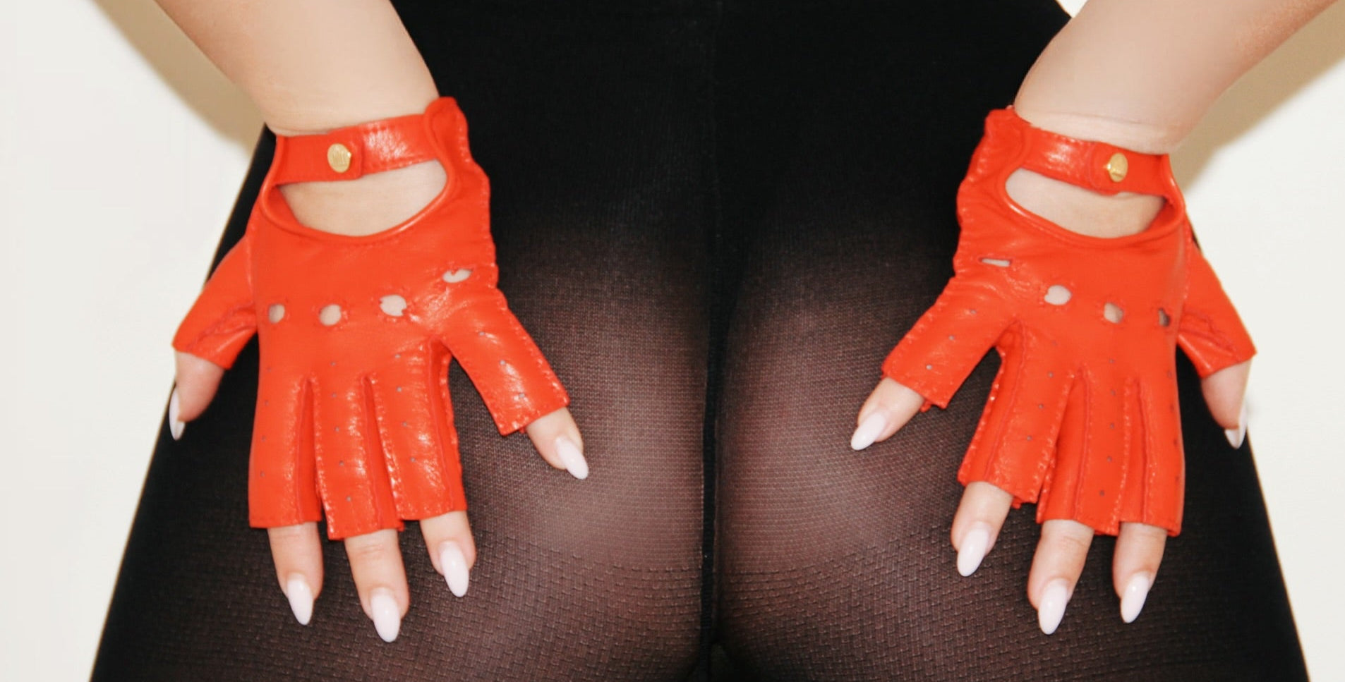 Liv red leather fingerless gloves with perforated detail and gold snap